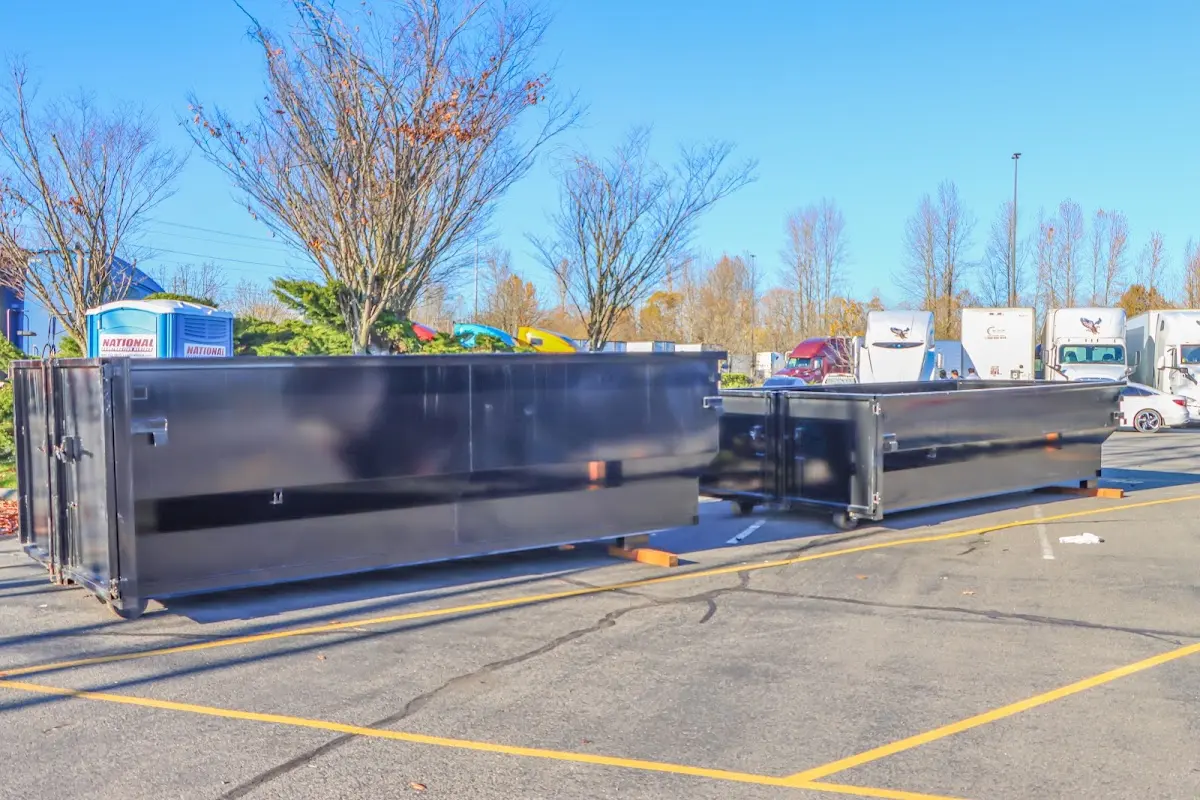 Professional dumpster rental service with roll-off container on residential driveway in Whitewater